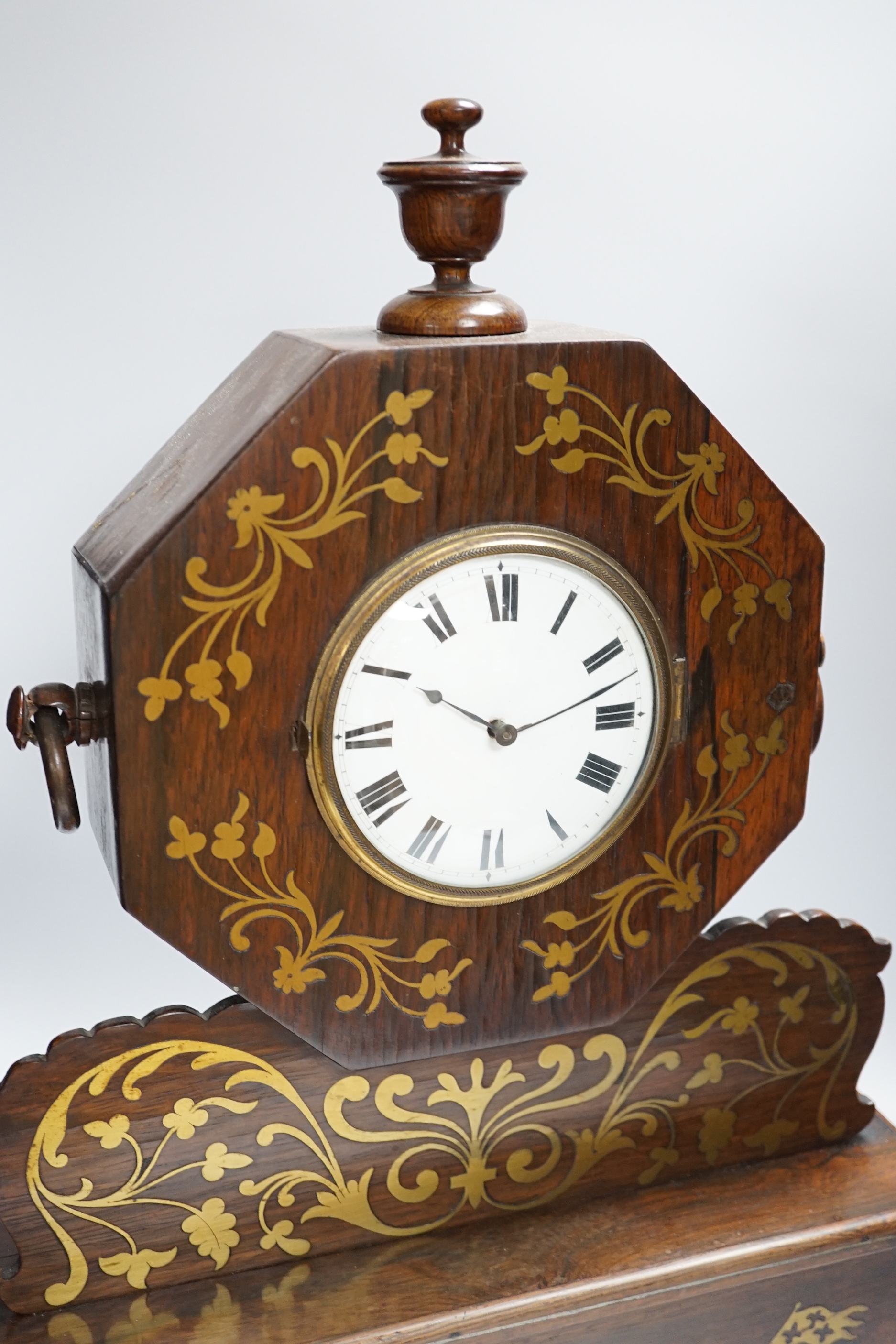 A 19th century rosewood and cut brass mantel clock, inlaid heraldic horse racing panel, 53cm high